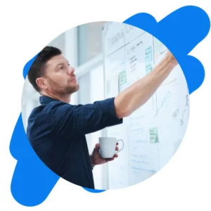 Business strategist annotating an innovation portfolio roadmap on a whiteboard in a modern office.